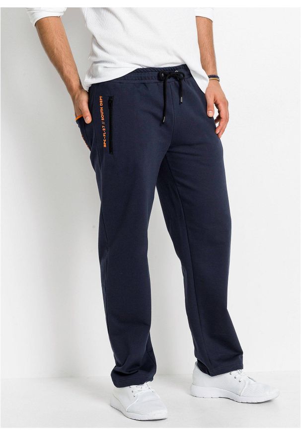 bonprix - Spodnie sportowe z praktycznymi kieszeniami zapinanymi na zamek. Kolor: niebieski. Styl: sportowy