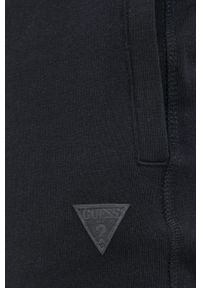Guess Spodnie męskie kolor czarny gładkie. Kolor: czarny. Materiał: dzianina, bawełna. Wzór: gładki