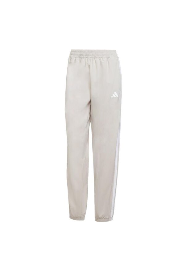 Adidas - Spodnie Train Essentials 3-Stripes Woven. Kolor: beżowy, wielokolorowy, biały. Materiał: materiał. Technologia: ClimaCool (Adidas). Sport: fitness