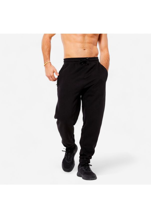 DOMYOS - Spodnie dresowe męskie Domyos Gym & Pilates. Kolor: czarny. Materiał: materiał, poliester, bawełna. Wzór: ze splotem. Sezon: zima. Sport: joga i pilates