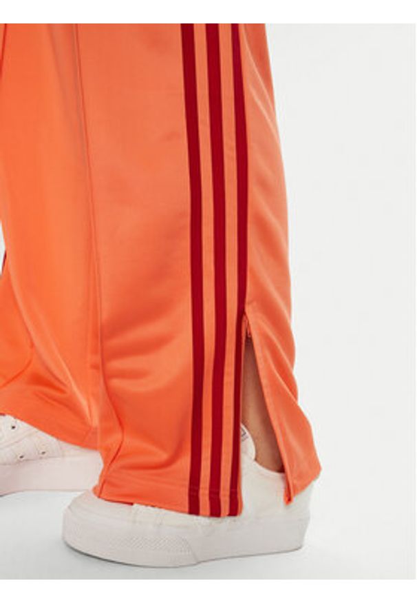 Adidas - adidas Spodnie dresowe adicolor Classic Firebird JP2309 Pomarańczowy Loose Fit. Kolor: pomarańczowy. Materiał: syntetyk