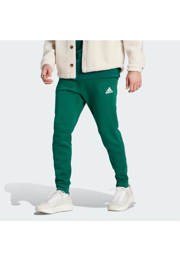 Adidas - Spodnie Essentials Fleece Regular Tapered. Kolor: zielony. Materiał: dresówka. Sport: taniec, joga i pilates