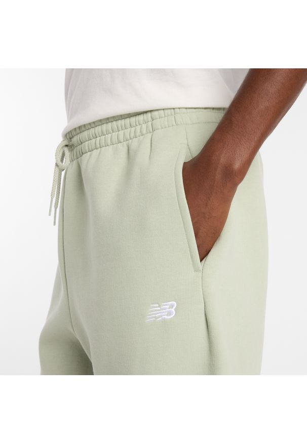 Spodnie męskie New Balance MP41503GAS – miętowe. Kolor: miętowy. Materiał: poliester, bawełna, dresówka, materiał
