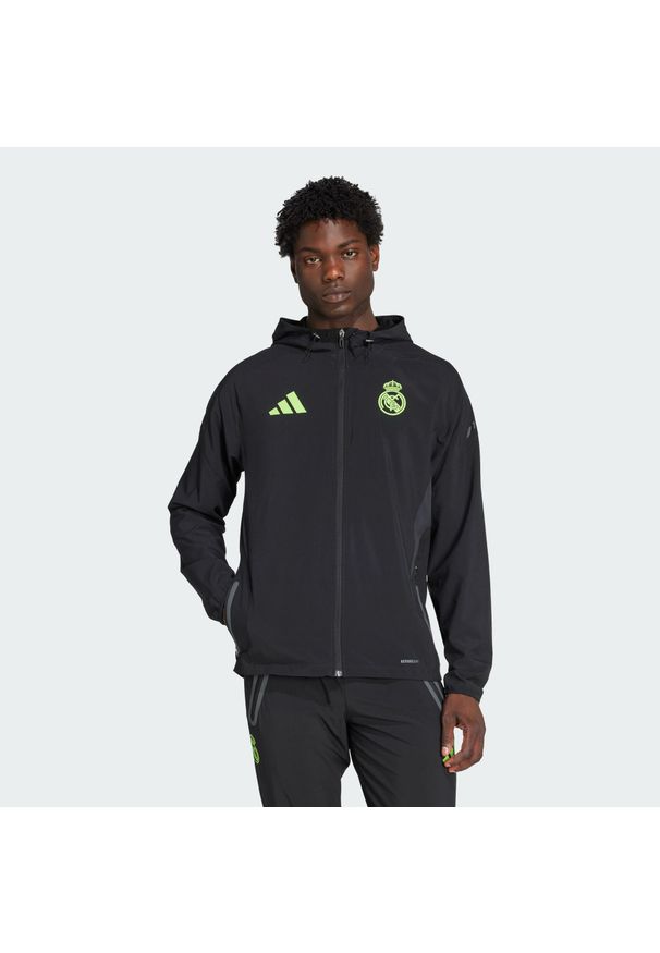 Adidas - Kurtka podróżna Real Madryt Tiro 25 Pro Vis Tech. Kolor: czarny, wielokolorowy, żółty. Materiał: dresówka. Sport: piłka nożna