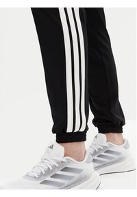 Adidas - adidas Spodnie dresowe Tricot 3-Stripes JF3383 Czarny Regular Fit. Kolor: czarny. Materiał: syntetyk #9