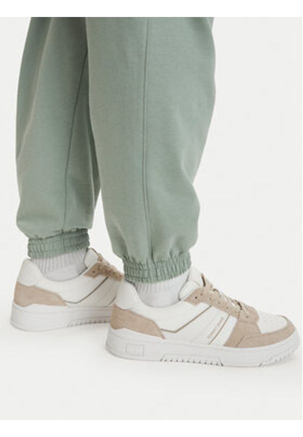 TOMMY HILFIGER - Tommy Hilfiger Spodnie dresowe Essential UM0UM03911 Zielony jasny Relaxed Fit. Kolor: zielony. Materiał: bawełna