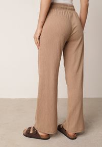 Born2be - Beżowe Szerokie Spodnie z Teksturalnej Tkaniny z Wiązaniem w Pasie Agatia. Okazja: do pracy, na co dzień, na spacer. Stan: podwyższony. Kolor: beżowy. Materiał: tkanina. Długość: długie. Styl: wakacyjny, casual #6