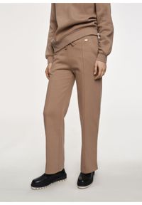 Ochnik - Damskie spodnie dresowe z przeszyciem. Kolor: beżowy. Materiał: bawełna