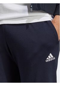 Adidas - adidas Spodnie dresowe Essentials IC0056 Granatowy Regular Fit. Kolor: niebieski. Materiał: syntetyk