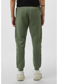 Guess - GUESS Zielone męskie spodnie dresowe z lampasami Mickey, Rozmiar XL. Kolor: zielony. Materiał: dresówka #5