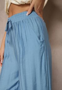 Renee - Niebieskie Spodnie Typu Palazzo o Szerokim Kroju High Waist Ozdobione Wiązaniem Yaslevia. Okazja: na co dzień. Stan: podwyższony. Kolor: niebieski. Wzór: aplikacja. Styl: casual, elegancki