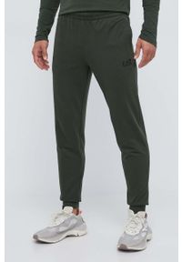 EA7 Emporio Armani spodnie dresowe bawełniane kolor zielony gładkie. Kolor: zielony. Materiał: bawełna, dresówka. Wzór: gładki