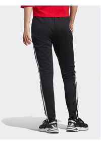 Adidas - adidas Spodnie dresowe adicolor IB5916 Czarny Slim Fit. Kolor: czarny. Materiał: bawełna