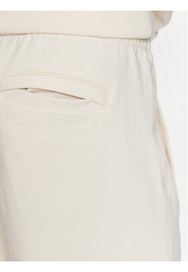 New Balance Spodnie dresowe MP23551 Écru Relaxed Fit. Materiał: bawełna