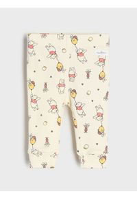 Sinsay - Bawełniane legginsy ze wzorem Winnie the Pooh - beżowy. Kolor: beżowy. Materiał: bawełna #1