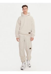 Champion Spodnie dresowe 220415 Écru Loose Fit. Materiał: bawełna