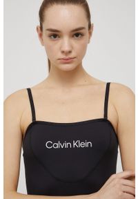 Calvin Klein Performance top treningowy Big Idea kolor czarny. Kolor: czarny. Materiał: dzianina, poliester, skóra. Długość rękawa: na ramiączkach
