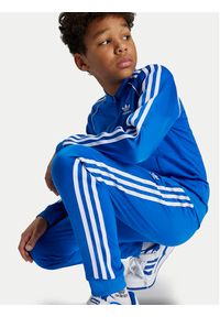 Adidas - adidas Spodnie dresowe adicolor SST IY4007 Niebieski Regular Fit. Kolor: niebieski. Materiał: syntetyk