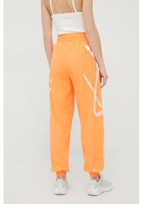 Adidas by Stella McCartney - adidas by Stella McCartney spodnie treningowe Truepace HC2985 damskie kolor pomarańczowy z nadrukiem. Kolor: pomarańczowy. Materiał: materiał. Wzór: nadruk #4