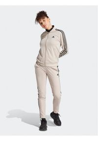 Adidas - adidas Dres Essentials 3-Stripes IJ8786 Beżowy Slim Fit. Kolor: beżowy. Materiał: dresówka, syntetyk