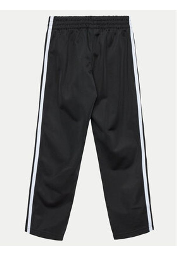 Adidas - adidas Spodnie dresowe Firebird IY9805 Czarny Regular Fit. Kolor: czarny. Materiał: syntetyk