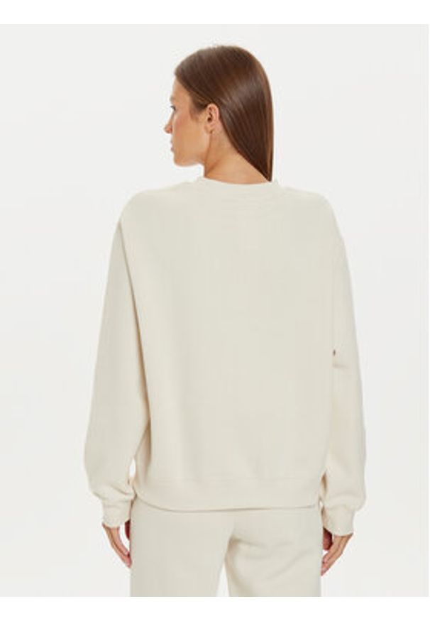 New Balance Bluza WT43516 Beżowy Relaxed Fit. Kolor: beżowy. Materiał: bawełna, syntetyk