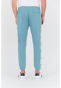 Guess - GUESS Turkusowe dresowe spodnie New Arlo. Kolor: niebieski. Materiał: dresówka #5