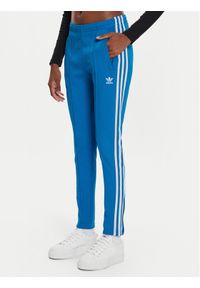 Adidas - adidas Spodnie dresowe adicolor SST IL8817 Niebieski Slim Fit. Kolor: niebieski. Materiał: bawełna #1