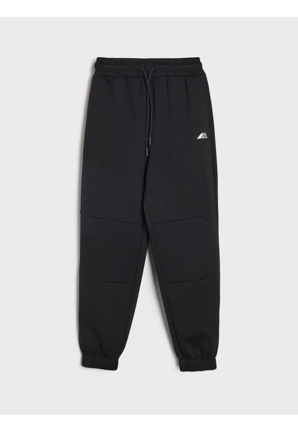Sinsay - Spodnie dresowe loose - czarny. Kolor: czarny. Materiał: dresówka