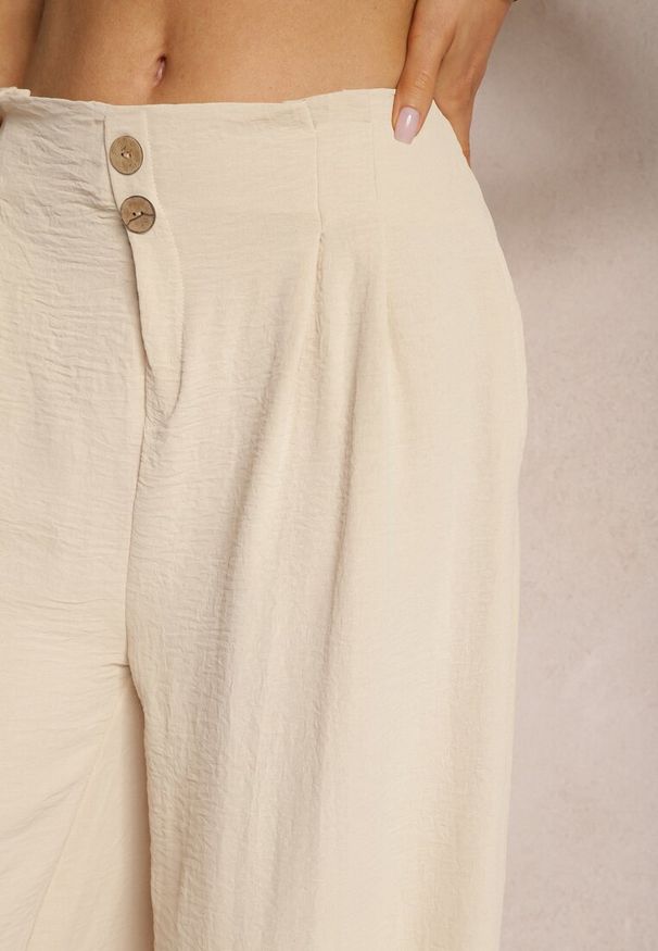 Renee - Beżowe Spodnie w Stylu Alladynek High Waist Wykończone Gumką w Pasie Riselma. Okazja: na co dzień. Stan: podwyższony. Kolor: beżowy. Styl: sportowy, casual