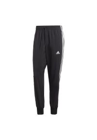 Adidas - AEROREADY Essentials Tapered Cuff Woven 3-Stripes Pants. Kolor: czarny, wielokolorowy, biały. Materiał: materiał, dresówka