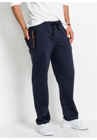 bonprix - Spodnie sportowe z praktycznymi kieszeniami zapinanymi na zamek. Kolor: niebieski. Styl: sportowy #1
