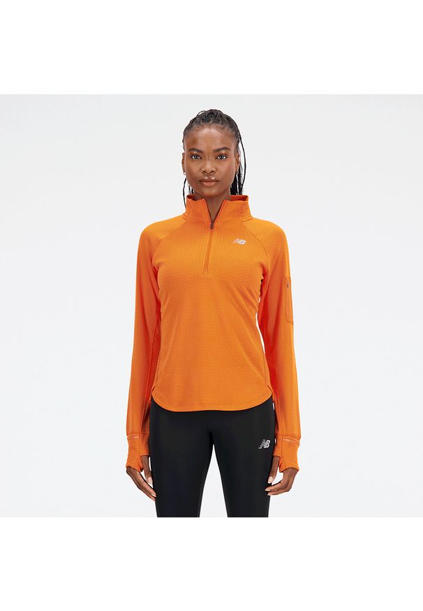 Bluza damska New Balance WT23252CEN – pomarańczowa. Kolor: pomarańczowy. Materiał: tkanina, poliester, polar, materiał, dresówka, skóra. Długość: długie. Sezon: zima. Sport: fitness