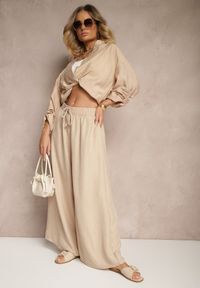 Renee - Beżowe Szerokie Spodnie High Waist Ozdobione Wiązaniem Telonia. Okazja: na co dzień. Stan: podwyższony. Kolor: beżowy. Wzór: aplikacja. Styl: casual, elegancki