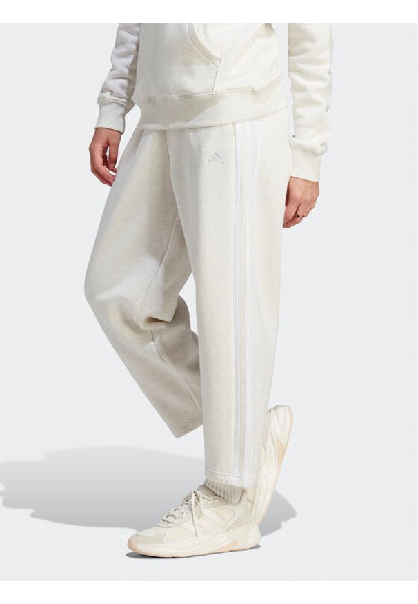 Adidas - adidas Spodnie dresowe Essentials 3-Stripes Open Hem Fleece IM0248 Écru Loose Fit. Materiał: bawełna