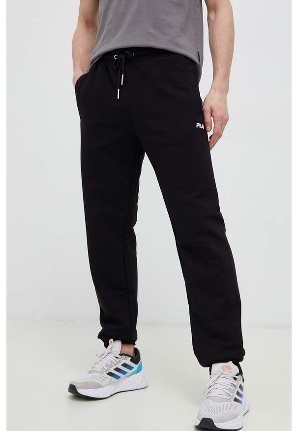 Fila spodnie dresowe kolor czarny gładkie. Kolor: czarny. Materiał: dresówka. Wzór: gładki