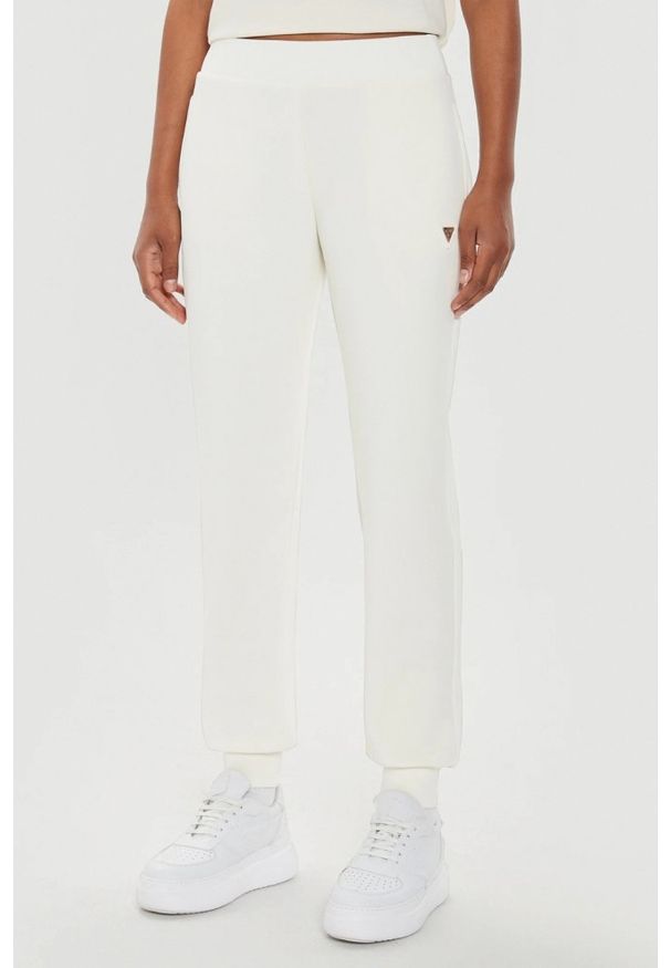 Guess - GUESS Beżowe damskie spodnie dresowe Olympe, Rozmiar S. Kolor: beżowy. Materiał: dresówka