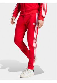 Adidas - adidas Spodnie dresowe adicolor Classics SST IM4543 Czerwony Slim Fit. Kolor: czerwony. Materiał: bawełna, syntetyk #1