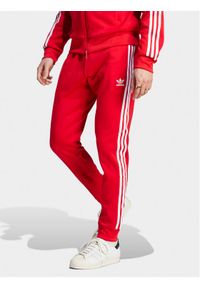 Adidas - adidas Spodnie dresowe adicolor Classics SST IM4543 Czerwony Slim Fit. Kolor: czerwony. Materiał: bawełna