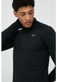 Reebok longsleeve do biegania Quarter-Zip kolor czarny gładki. Kolor: czarny. Materiał: poliester, skóra, materiał. Długość rękawa: długi rękaw. Długość: krótkie. Wzór: gładki #1