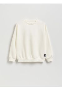 Reserved - Bluza oversize z nadrukiem - złamana biel. Materiał: dzianina. Wzór: nadruk