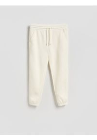Reserved - Spodnie dresowe regular fit - złamana biel. Materiał: dresówka