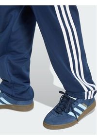 Adidas - adidas Spodnie dresowe Firebird HZ6650 Granatowy Regular Fit. Kolor: niebieski. Materiał: syntetyk #2