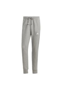 Adidas - Spodnie dresowe męskie adidas Essentials French Terry Tapered Cuff 3-Stripes. Kolor: biały, szary, wielokolorowy, fioletowy. Materiał: dresówka