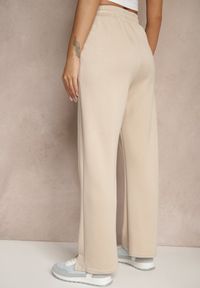 Renee - Beżowe Szerokie Spodnie Dresowe High Waist Ozdobione Sznurkiem Haliran. Okazja: na co dzień, na spacer. Stan: podwyższony. Kolor: beżowy. Materiał: dresówka. Wzór: aplikacja. Styl: elegancki, casual