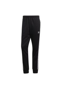 Adidas - Spodnie adidas Adicolor Classics Primeblue SST Track Pants GF0210 - czarne. Kolor: czarny. Materiał: bawełna, guma, poliester, dresówka. Wzór: aplikacja #1