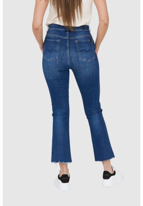 7 FOR ALL MANKIND Ciemnoniebieskie jeansy damskie z poszarpanymi nogawkami HW Slim Kick. Kolor: niebieski