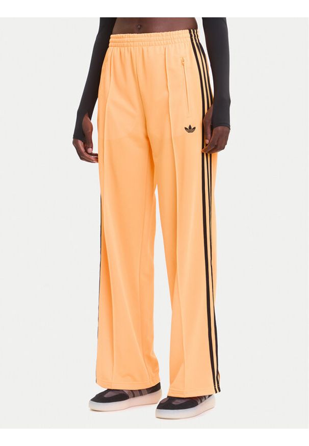 Adidas - adidas Spodnie dresowe adicolor Classic Firebird JY2694 Żółty Loose Fit. Kolor: żółty. Materiał: syntetyk