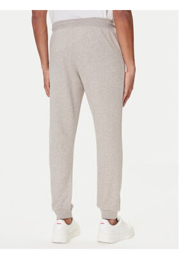 TOMMY HILFIGER - Tommy Hilfiger Spodnie dresowe UM0UM03664 Beżowy Regular Fit. Kolor: beżowy. Materiał: syntetyk, bawełna