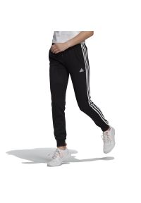 Adidas - Spodnie adidas Essentials French Terry 3-Stripes GM8733 - czarne. Kolor: czarny. Materiał: bawełna, dresówka, poliester, wiskoza. Wzór: paski. Sport: fitness